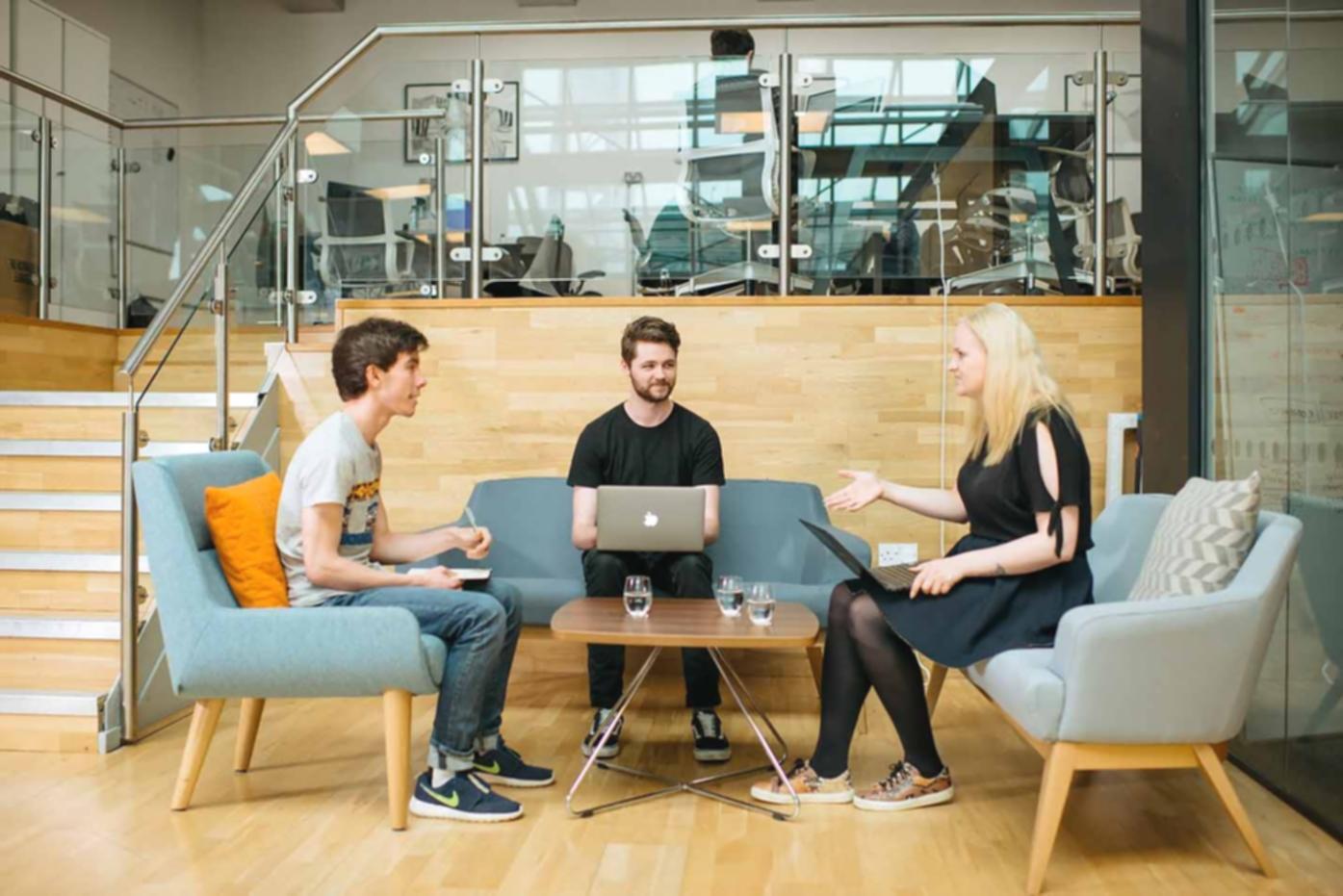 Professional advisory setting showing collaborative family investment planning discussion with documents and financial materials on table